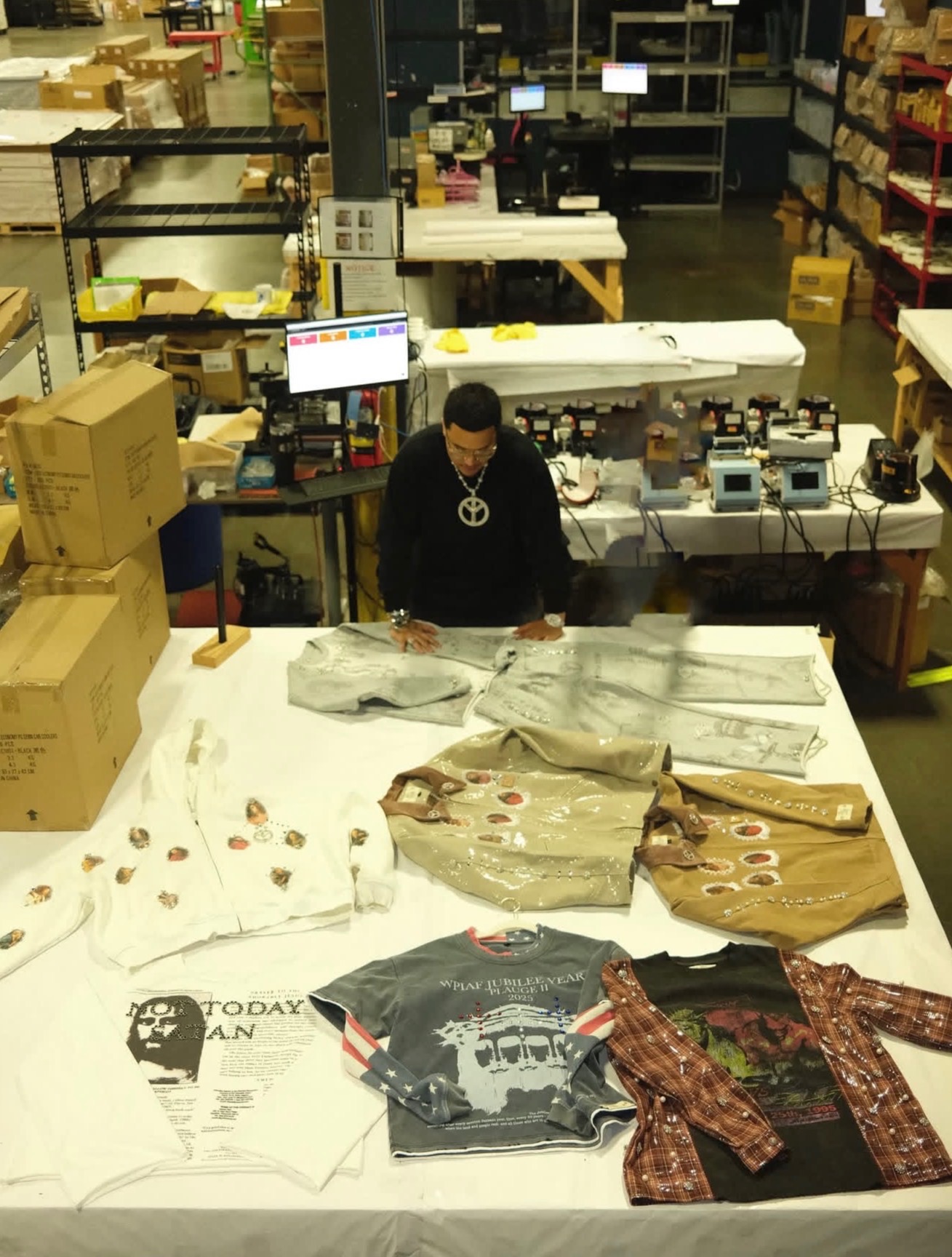 Product line laid out on the fulfilment floor with the team reviewing pieces